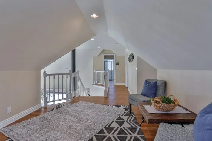 This upper-level lounge features two plush chairs, combining comfort and functionality for productive work or leisurely downtime.