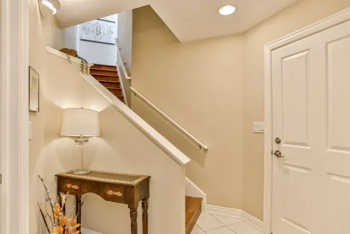 A sleek, modern stairway located in the common area seamlessly connects the home’s levels, blending functionality with contemporary design.
