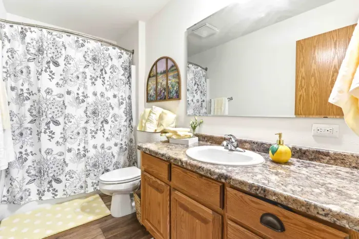 Refresh and unwind in a clean, cheerful bathroom with warm finishes and thoughtful touches for an easy stay.