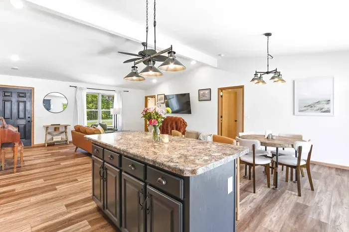 Gather with ease around the spacious island in an open, light-filled space made for cooking, dining, and relaxed conversation.