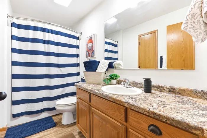 Refresh after the day’s adventures in a bright, cheerful bathroom with warm finishes and crisp blue accents.