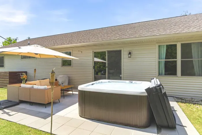Ease into vacation mode on the patio, where bubbling water, cozy seating, and nature set the scene.