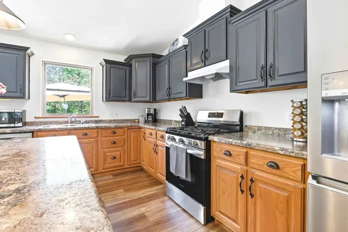 Cook with ease in a bright, well-equipped kitchen with generous counter space and peaceful backyard views.