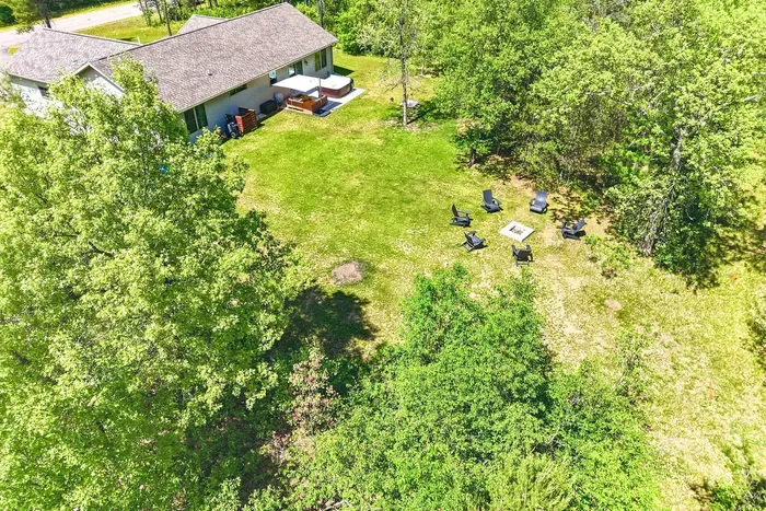 Escape to a spacious, tree-lined backyard with room to roam, soak, gather, and unwind around the fire pit.