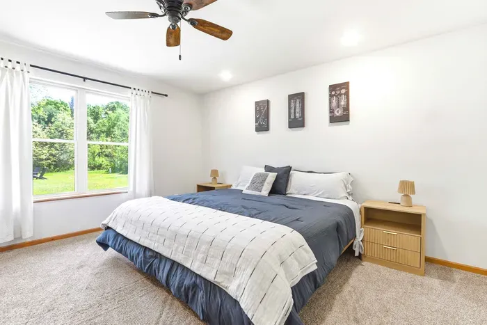 Wake up to peaceful green views in a bright, comfortable bedroom designed for restful nights and easy mornings.
