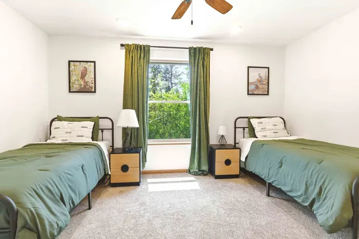 Rest comfortably in a cheerful twin bedroom with calming green tones, soft natural light, and leafy views.