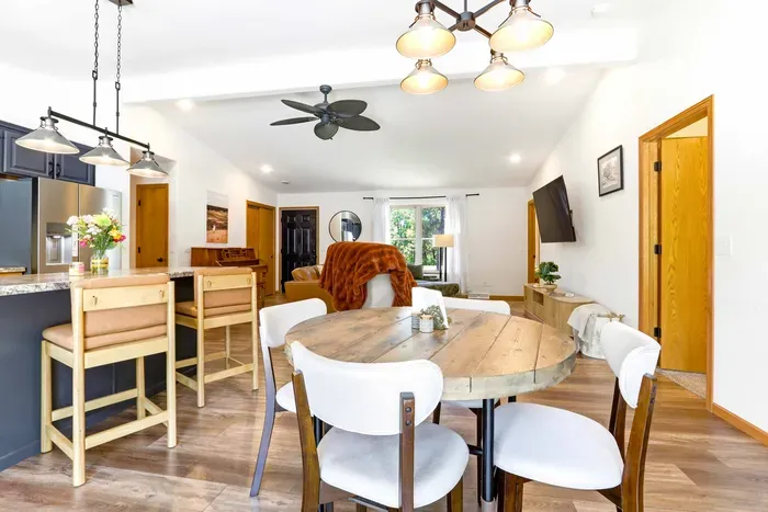Share easy meals and cozy conversation in an open dining space that flows naturally into the kitchen and living room.