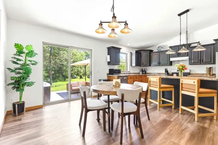 Savor easy meals and morning coffee in a sunlit dining space that opens seamlessly to the patio and peaceful backyard views.