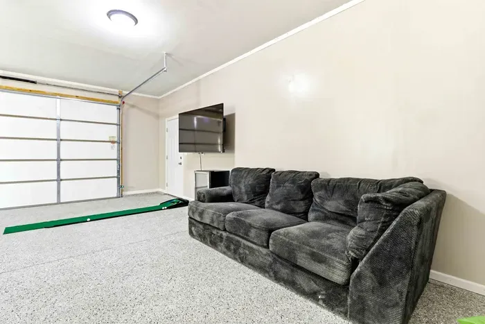 Kick back between games in a casual rec space with comfy lounge seating, a TV, and room for laid-back fun.