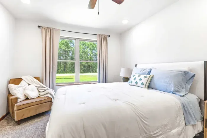 Wake up surrounded by natural light and greenery in a serene bedroom made for slow, comfortable mornings.