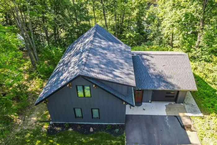 Tucked beneath the trees, this modern cabin welcomes you with quiet privacy and easy driveway parking.