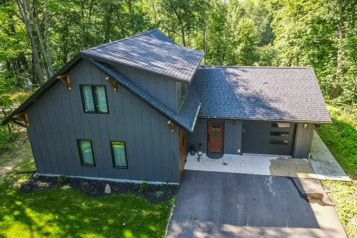 Enjoy a serene arrival surrounded by lush greenery, with convenient private driveway access leading right to the home.