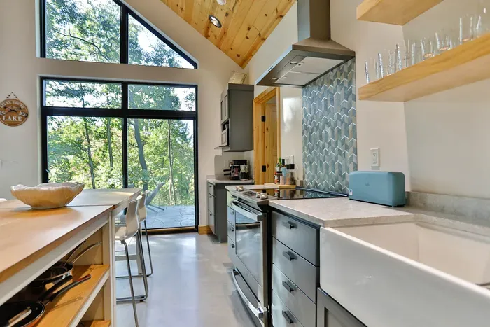 Cook with ease in this clean, spacious kitchen featuring a full stove, dishwasher, and more.