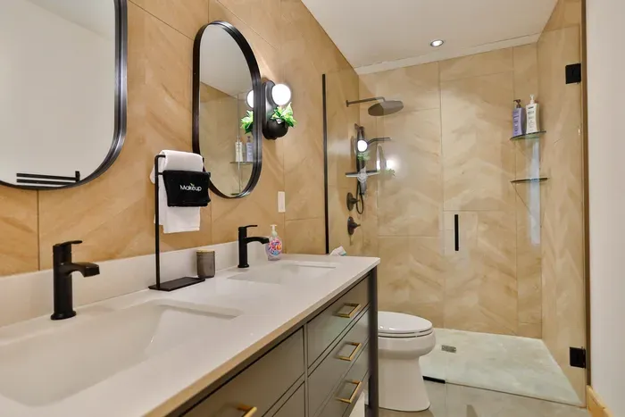 Bright, well-stocked bathroom with towels, and thoughtful touches.