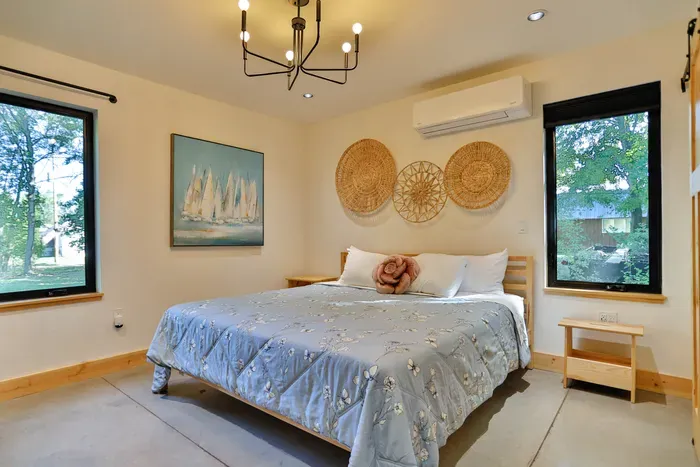 Relax and recharge in the spacious primary bedroom with a plush king-size bed and quality linens.