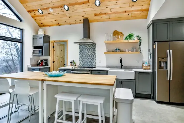 Cook with ease in this clean, spacious kitchen featuring a full stove, dishwasher, and more.