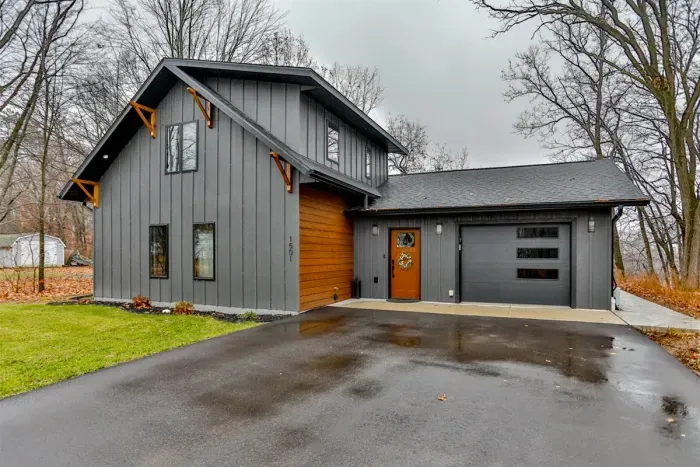 Modern lakefront chalet with clean lines, natural surroundings, and scenic mountain views.