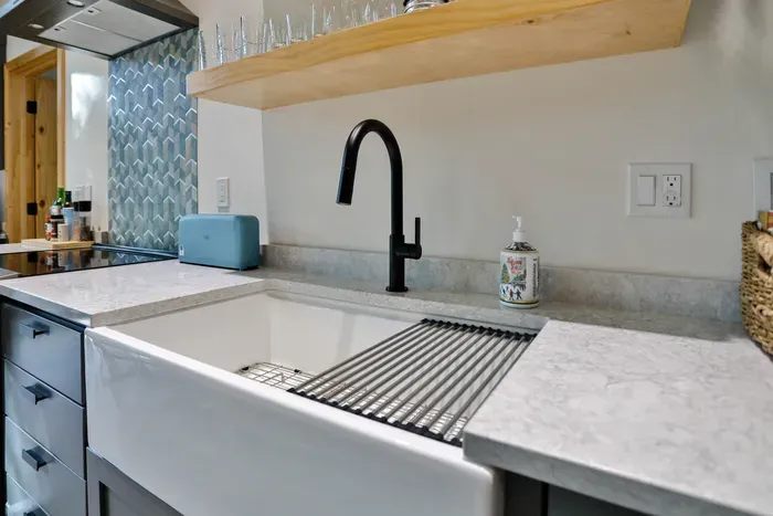 Clean, spacious kitchen with deep sink and all the essentials for easy cleanup.