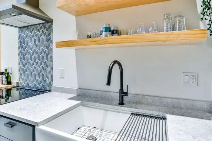 Clean, spacious kitchen with deep sink and all the essentials for easy cleanup.
