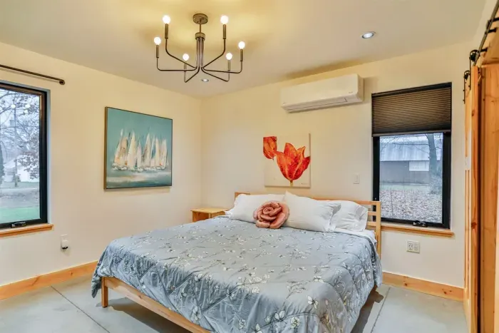 Relax and recharge in the spacious primary bedroom with a plush king-size bed and quality linens.