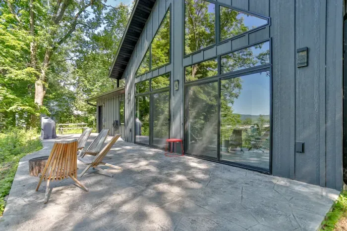 Relax on the outdoor patio seating while enjoying peaceful wooded views and fresh air.
