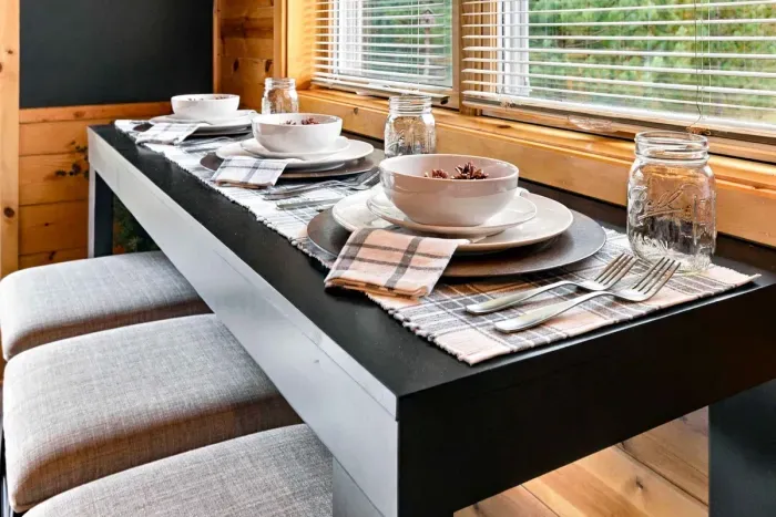 Enjoy morning coffee or intimate dinners at this fully set dining nook, complete with comfortable cushioned stools.