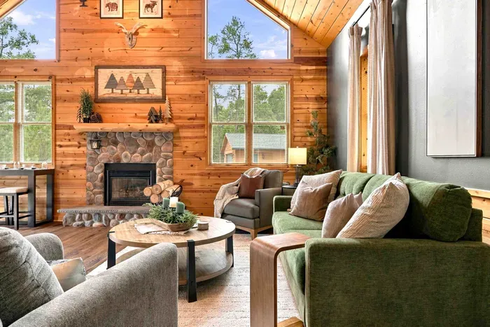 Settle into the cozy lounge area equipped with a grand stone fireplace, comfortable armchairs, and an elegant sofa.
