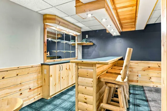 Pour your favorite drink and pull up a seat at the handcrafted home bar, outfitted with wooden swivel barstools.