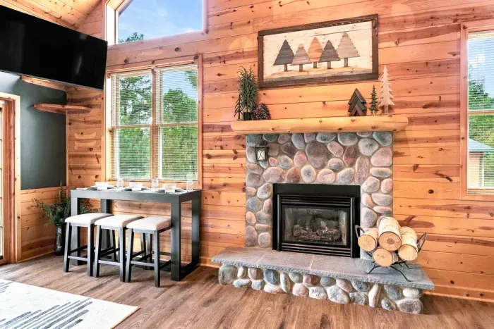 Gather around a warm, focal-point stone fireplace or enjoy casual dining and drinks at the adjacent pub-style table with seating.