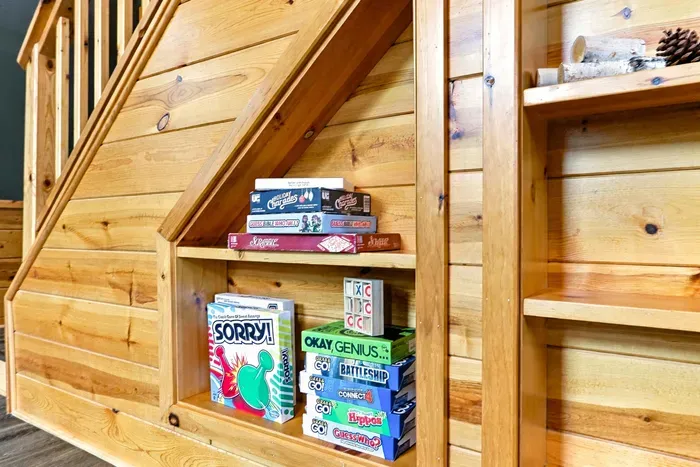 Gather family and friends for friendly competition with a selection of classic board games neatly tucked into custom wooden shelving.