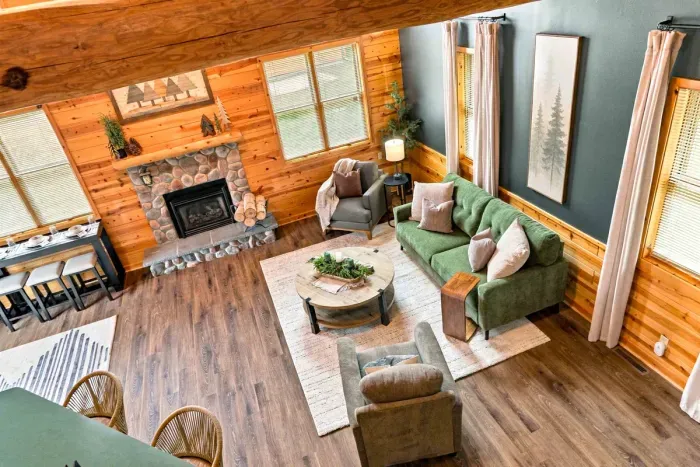 Gather in this light-filled main living space complete with a cozy fireplaces, comfortable lounge seating, and a seamless flow into the kitchen area.