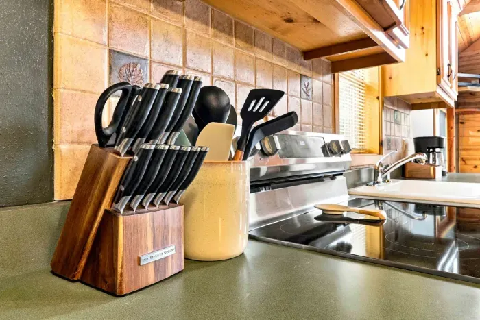 Prepare home-cooked meals with ease using a full knife block set and essential cooking utensils kept right beside the electric cooktop stove.