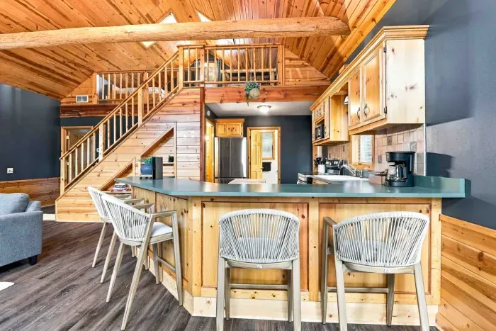 Cook and entertain effortlessly in a fully equipped kitchen complete with a large breakfast bar, updated appliances, and direct sightlines to the main living area.