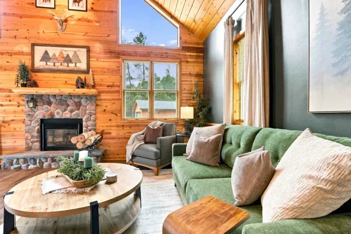 Sink into the plush sofas beneath soaring wood ceilings, where a classic stone fireplace and big-screen TV create the ultimate spot to relax.