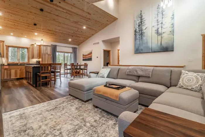 A stylish living room featuring a comfortable gray couch set against crisp white walls, creating a clean and modern space to relax.