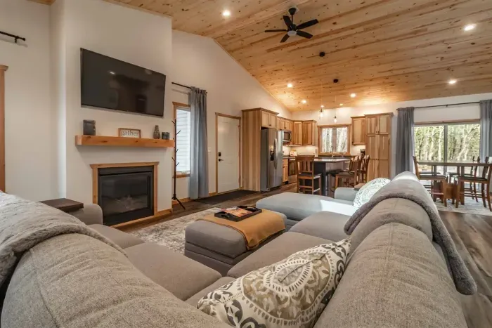 A stylish living room featuring a comfortable gray couch set against crisp white walls, creating a clean and modern space to relax.