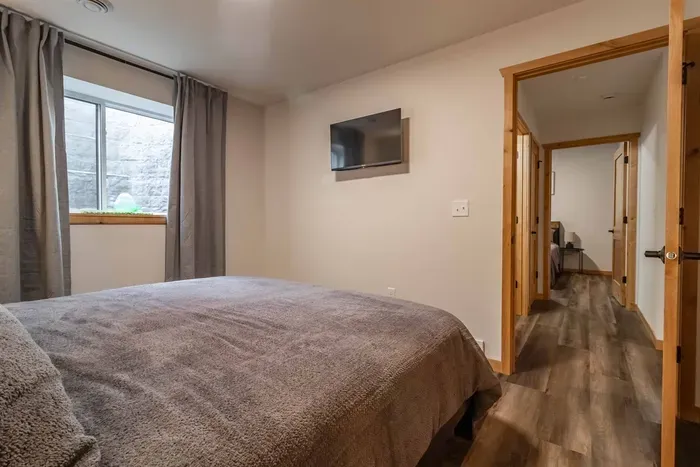 A cozy bedroom featuring elegant gray bedding that adds a modern, soothing touch for a comfortable night’s rest.