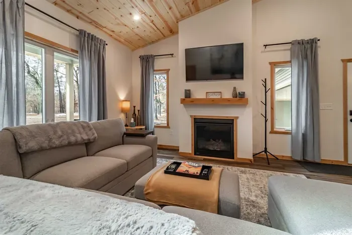 A stylish living room featuring a comfortable gray couch set against crisp white walls, creating a clean and modern space to relax.