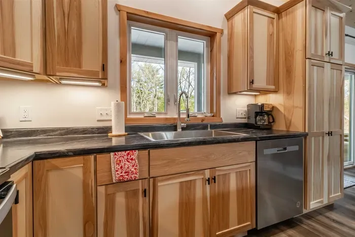 A welcoming kitchen and dining area highlighted by warm wood accents, blending natural charm with a comfortable space for meals and gatherings.