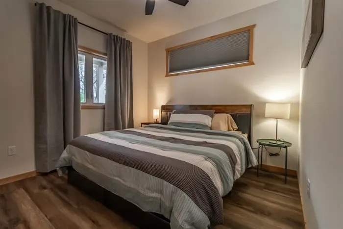 Minimalist bedroom with crisp white walls, offering a peaceful and uncluttered space to unwind.