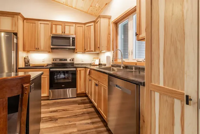 A welcoming kitchen and dining area highlighted by warm wood accents, blending natural charm with a comfortable space for meals and gatherings.