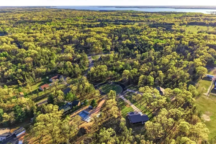Peaceful wooded location captured from above, offering a sense of privacy, space, and natural beauty.