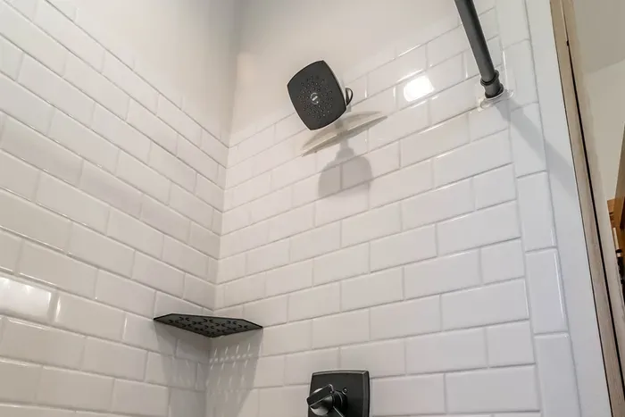 A comfortable bathroom with both a shower and a bathtub, perfect for quick refreshes or relaxing soaks.