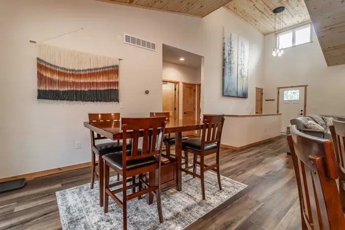 A welcoming kitchen and dining area highlighted by warm wood accents, blending natural charm with a comfortable space for meals and gatherings.