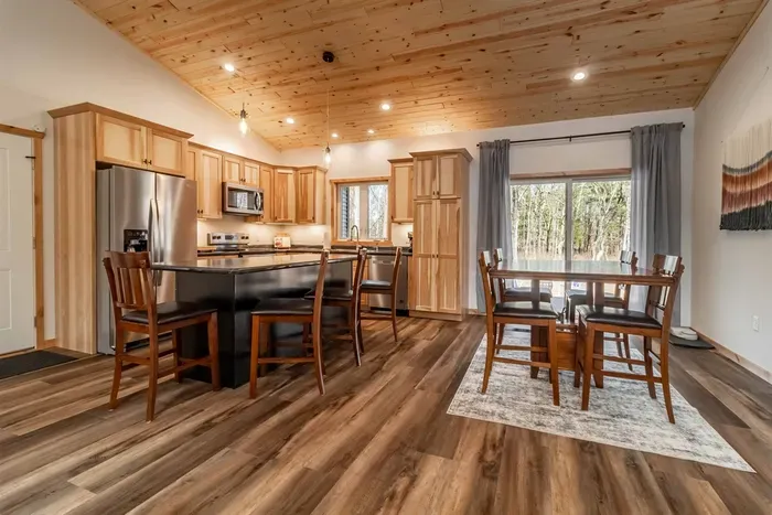 A welcoming kitchen and dining area highlighted by warm wood accents, blending natural charm with a comfortable space for meals and gatherings.