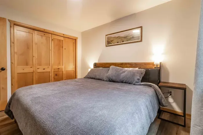 A cozy bedroom featuring elegant gray bedding that adds a modern, soothing touch for a comfortable night’s rest.