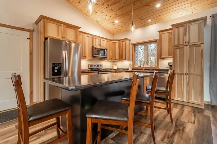 A welcoming kitchen and dining area highlighted by warm wood accents, blending natural charm with a comfortable space for meals and gatherings.