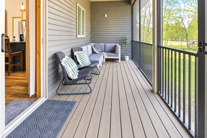 Your rain doesn't cancel anything here. The screened porch has a full sofa and forest views on every side — morning coffee or midnight wine, both work perfectly.