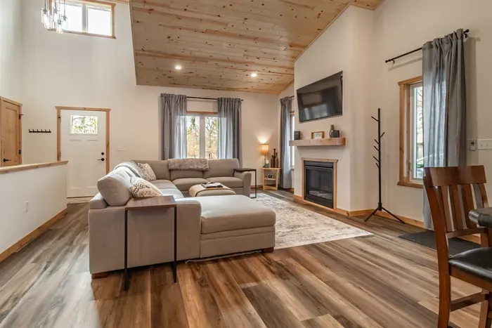 A stylish living room featuring a comfortable gray couch set against crisp white walls, creating a clean and modern space to relax.
