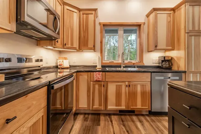 A welcoming kitchen and dining area highlighted by warm wood accents, blending natural charm with a comfortable space for meals and gatherings.